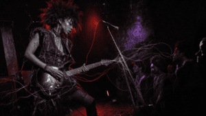 Editorial illustration of a young Black alternative-rock guitarist performing as luminous threads move through the stage